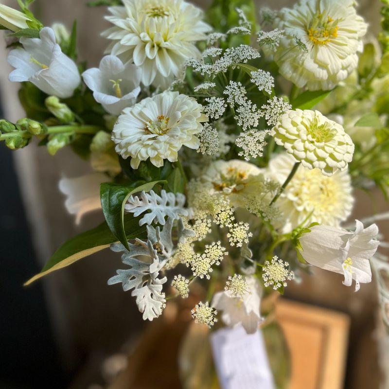 Funeral arrangement of white bellflower, dahlia and ammi